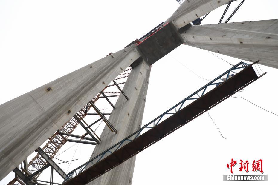 11月13日，记者来到位于贵州省黔南布依族苗族自治州平塘县境内的平塘特大桥建设工程进行探访。平塘特大桥经过两年多的建设，332米高主塔成功封顶，预计2019年年底建成。该桥全长2135米，设计速度80千米/每小时；桥面宽度24.5米。桥塔采用“钻石形”空间塔型，每座塔都由基桩、承台、塔身三部分组成，其中工程编号为16号的主塔塔高332米，为世界最高混凝土桥塔。 中新社记者 瞿宏伦 摄 图片来源：中新网