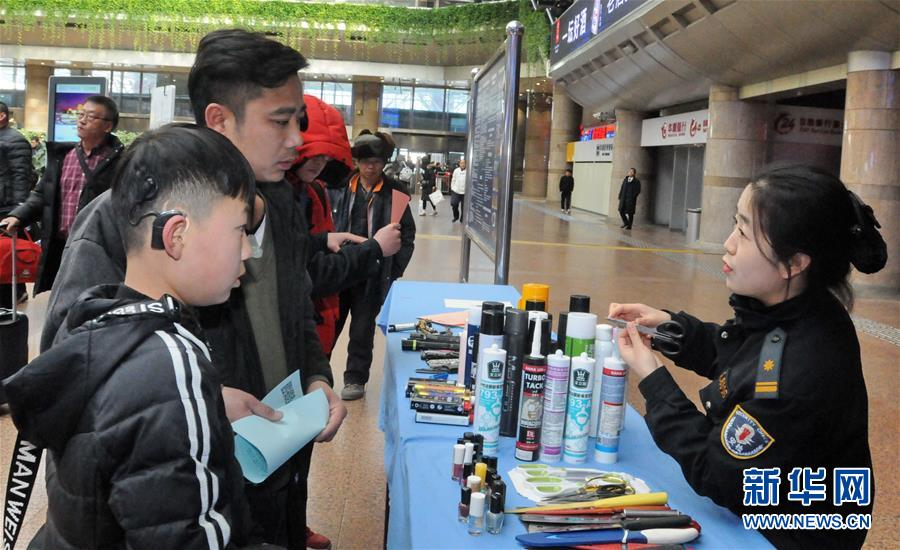 1月15日，北京铁路公安局西客站派出所的民警在给旅客讲解违禁物品的危害性。新华社发（张元 摄）