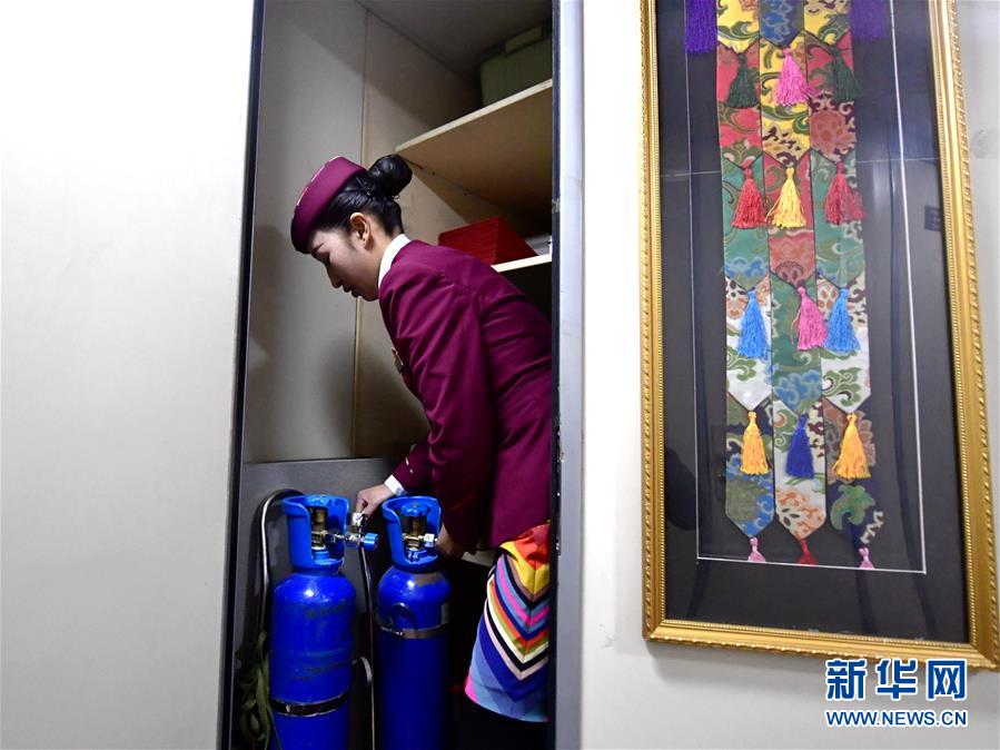1月21日，旦增央金在检查旅客车厢供氧设备。 在青藏铁路“唐竺古道号”Z6811次列车的乘务团队中，有一对藏族姐妹。姐姐贡久曲珍2007年参加工作，现在是该次列车的列车长；妹妹旦增央金2017年开始在列车上担任乘务员。从青海西宁到西藏日喀则的春运旅途上，姐妹俩用真诚的服务温暖着旅客的回家路。 新华社发（张龙摄）