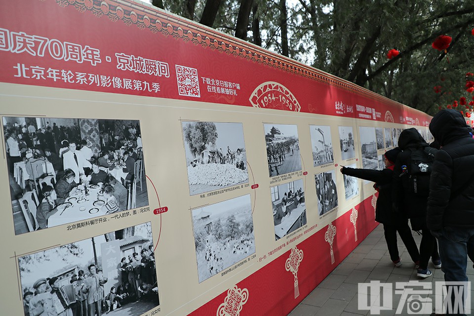 地坛庙会同时展开了“国庆70周年 京城瞬间”影像展，不时有游客驻足观看。中宏网记者 康书源 摄