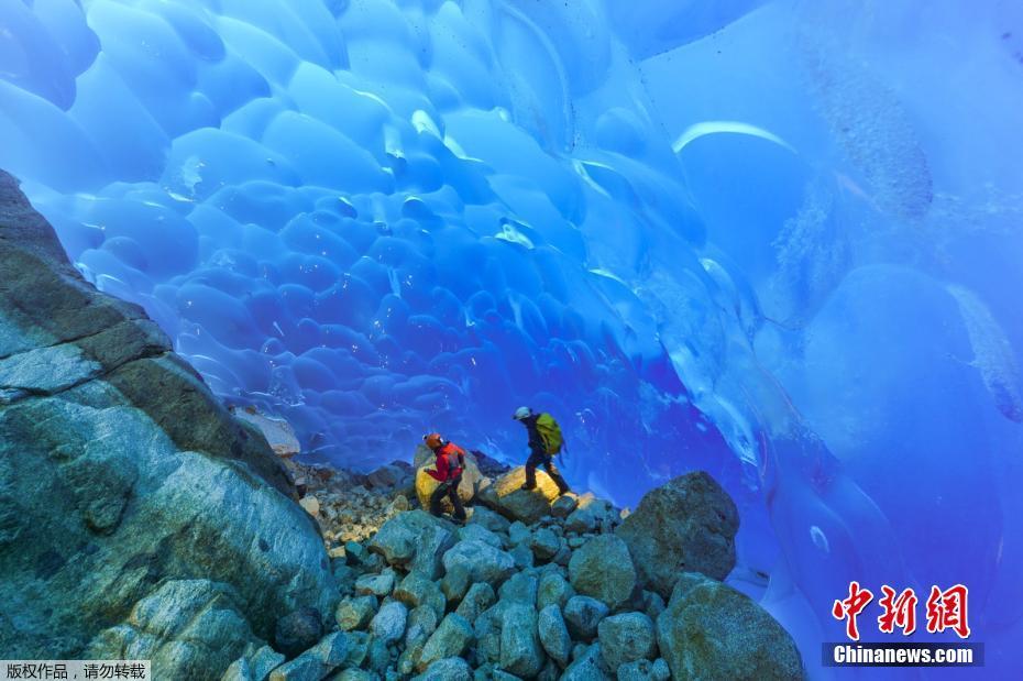 近日，几名法国科学家探险智利南部巴塔哥尼亚Madre de Dios群岛，攀冰穿洞，场面惊险刺激。图为两名科学家在岛上奇异风景中漫步。 图片来源：中新网