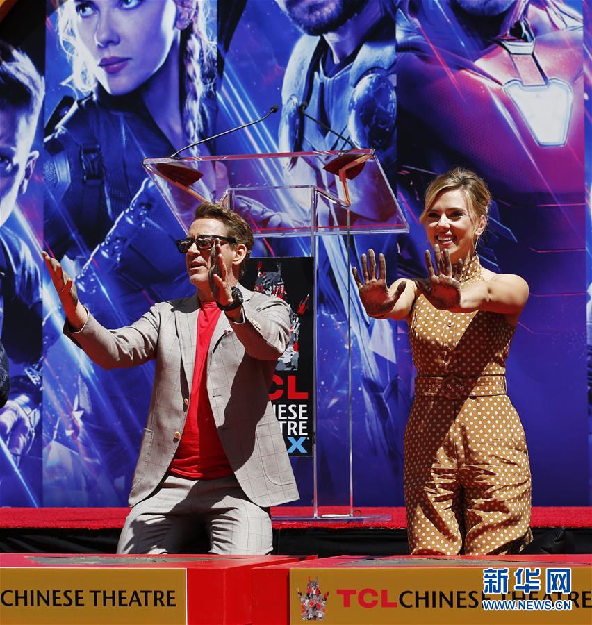 4月23日，在美国洛杉矶好莱坞TCL中国剧院门口，演员小罗伯特·唐尼（左）和斯嘉丽·约翰逊参加留印仪式。 当日，《复仇者联盟4：终局之战》部分演员在好莱坞TCL中国剧院门口留下手印。 新华社记者李颖摄