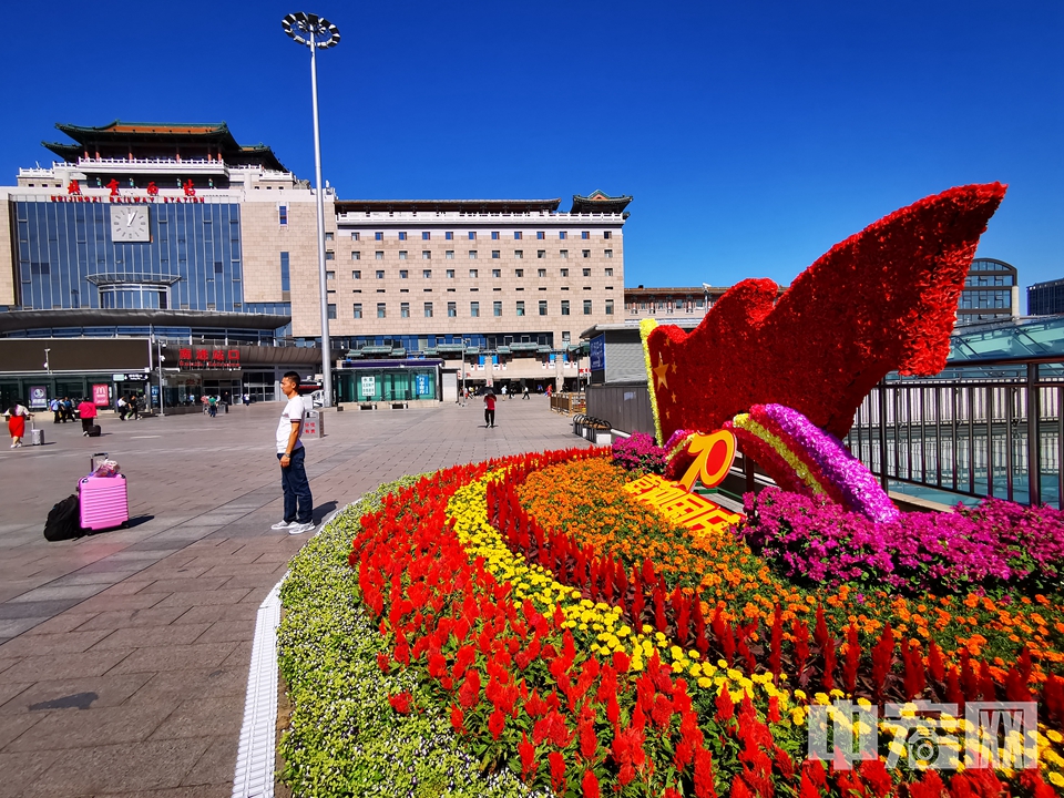 北京全市各区各地区采用主题花坛、容器花卉、花带花境等形式，因地制宜进行绿化景观布置，营造喜庆热烈的节日氛围。图为位于北京西站南广场的主题花坛。 中宏网记者 富宇 摄
