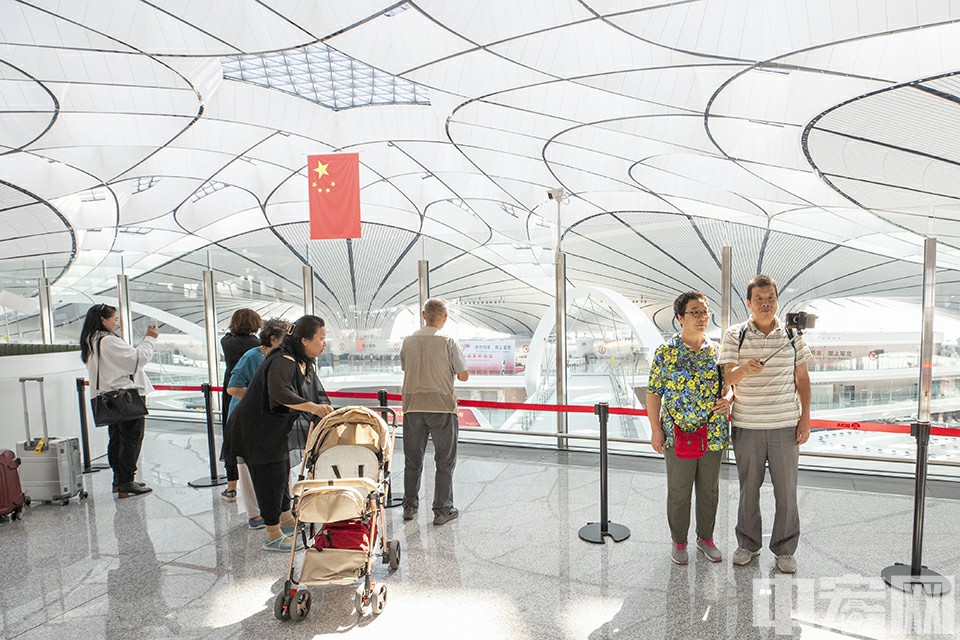 不少旅客前往位于机场五层的观景台拍照游览。中宏网记者 富宇 摄