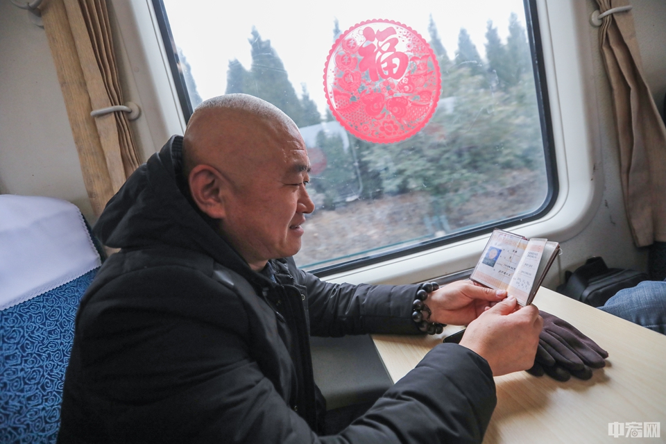 今年刚满50岁的梁涛是铁路济南工务段的监护道口工，和5个工友刚下夜班的他们准备回兖州，坐火车上下班是日常，如此往复已经20多年。看着新贴的窗花，工友感叹了一声时间过的真快。而经验丰富的梁涛翻出列车表说，这是首班加车，春节期间咱们下班就坐这趟车，方便。
