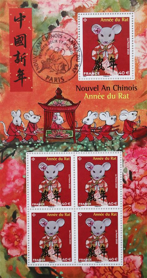这是1月19日在法国巴黎拍摄的中国农历鼠年生肖邮票。 为迎接中国农历新年，法国邮政公司发行两枚中国农历鼠年生肖邮票。鼠年生肖邮票由法籍华裔画家陈江洪设计。两枚邮票的上方和下方分别为法文和中文“鼠年”字样。其中一枚邮票的图案是一只老鼠手捧荷花，寓意和和美美；另一枚邮票以中国民间故事老鼠娶亲为主题，刻画了一只头戴鲜花的老鼠新娘。 新华社记者高静摄