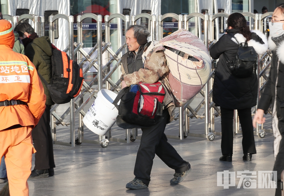 旅客肩扛行李进站。 中宏网记者 富宇 摄