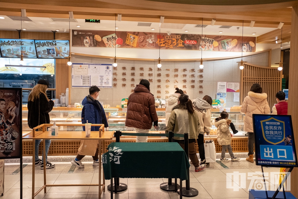 市民在龙湖房山天街内一家店铺排队购物。 中宏网记者 康书源 摄