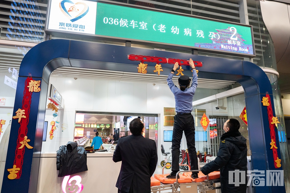 1月26日，北京西站，工作人员装饰候车大厅。