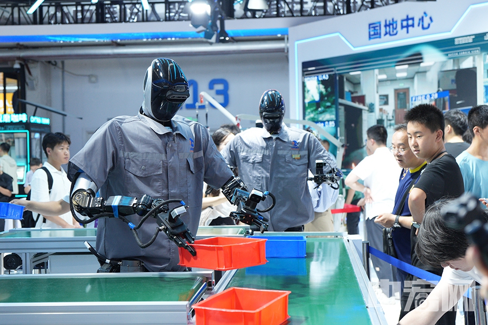機(jī)器人“工人”正在流水線上搬運物品。